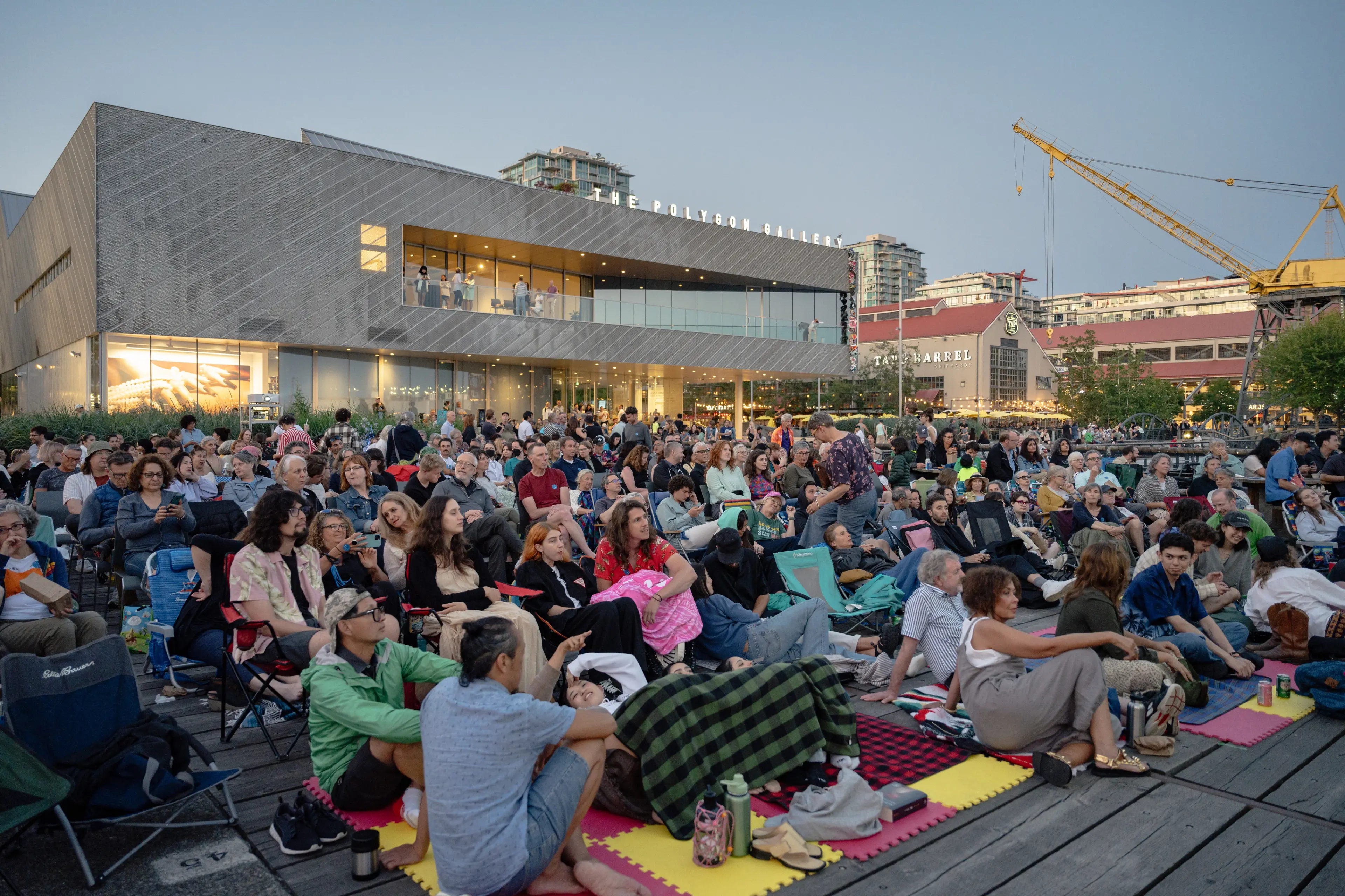 People watching an outdoor film at Deckchair Cinema at the Polygon Gallery.
