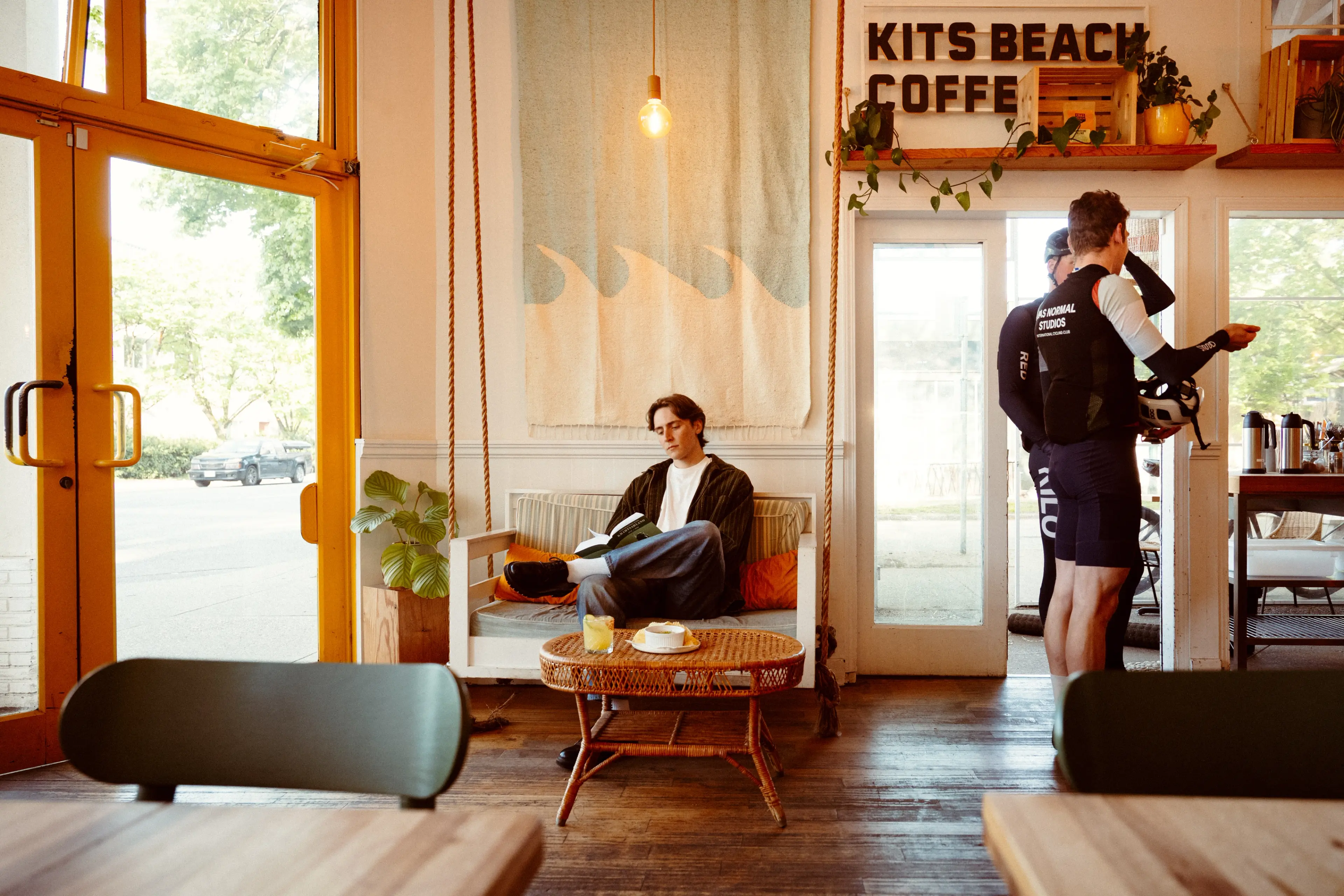 A person reading a book at the Kits Beach Coffee in Vancouver.