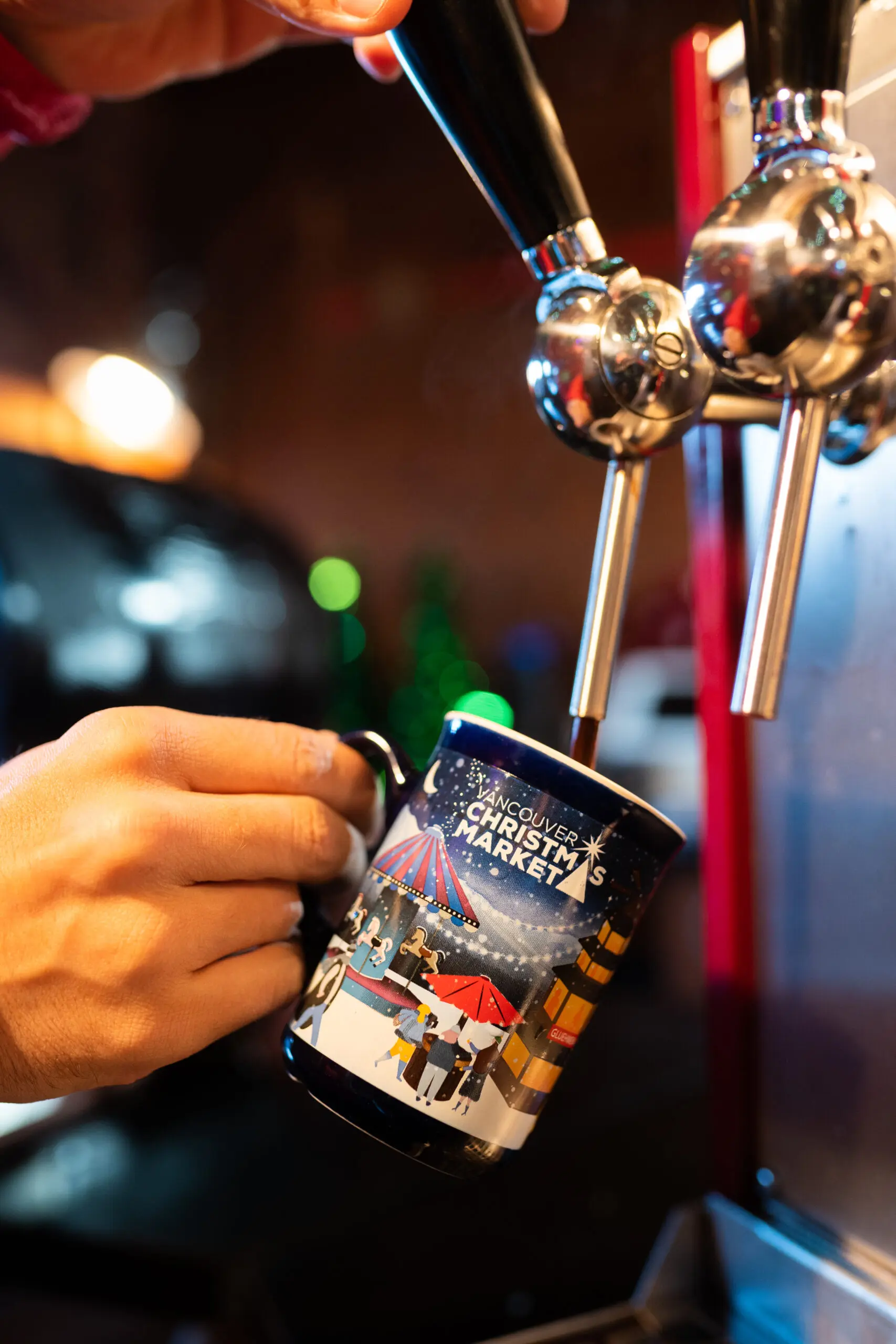 Pouring Gluhwein into a commemorative mug at the Vancouver Christmas Market