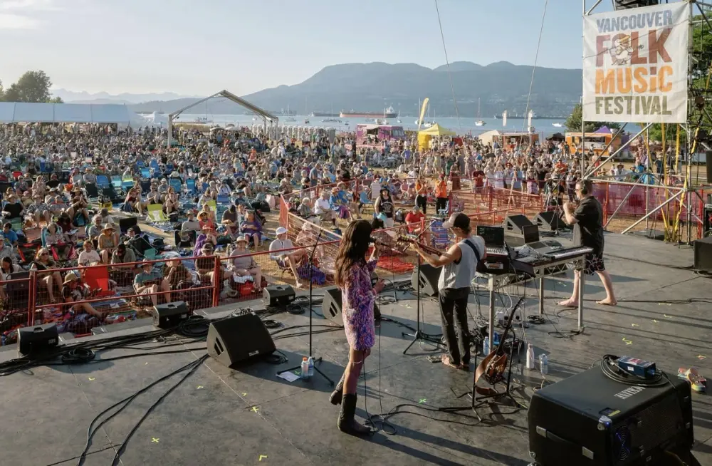 People watching a band on a stage during Vancouver Folk Music Festival
