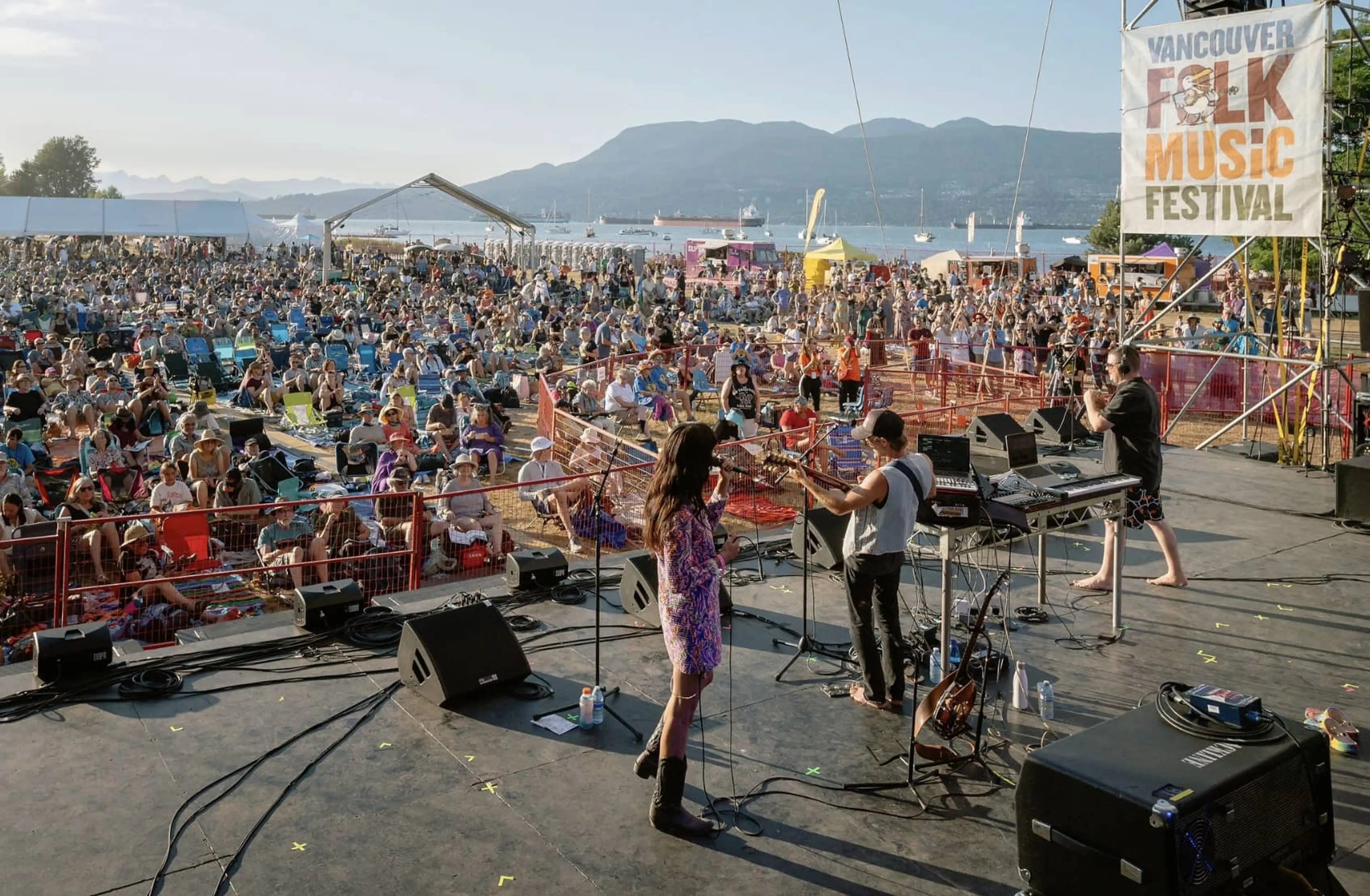 People watching a band on a stage during Vancouver Folk Music Festival