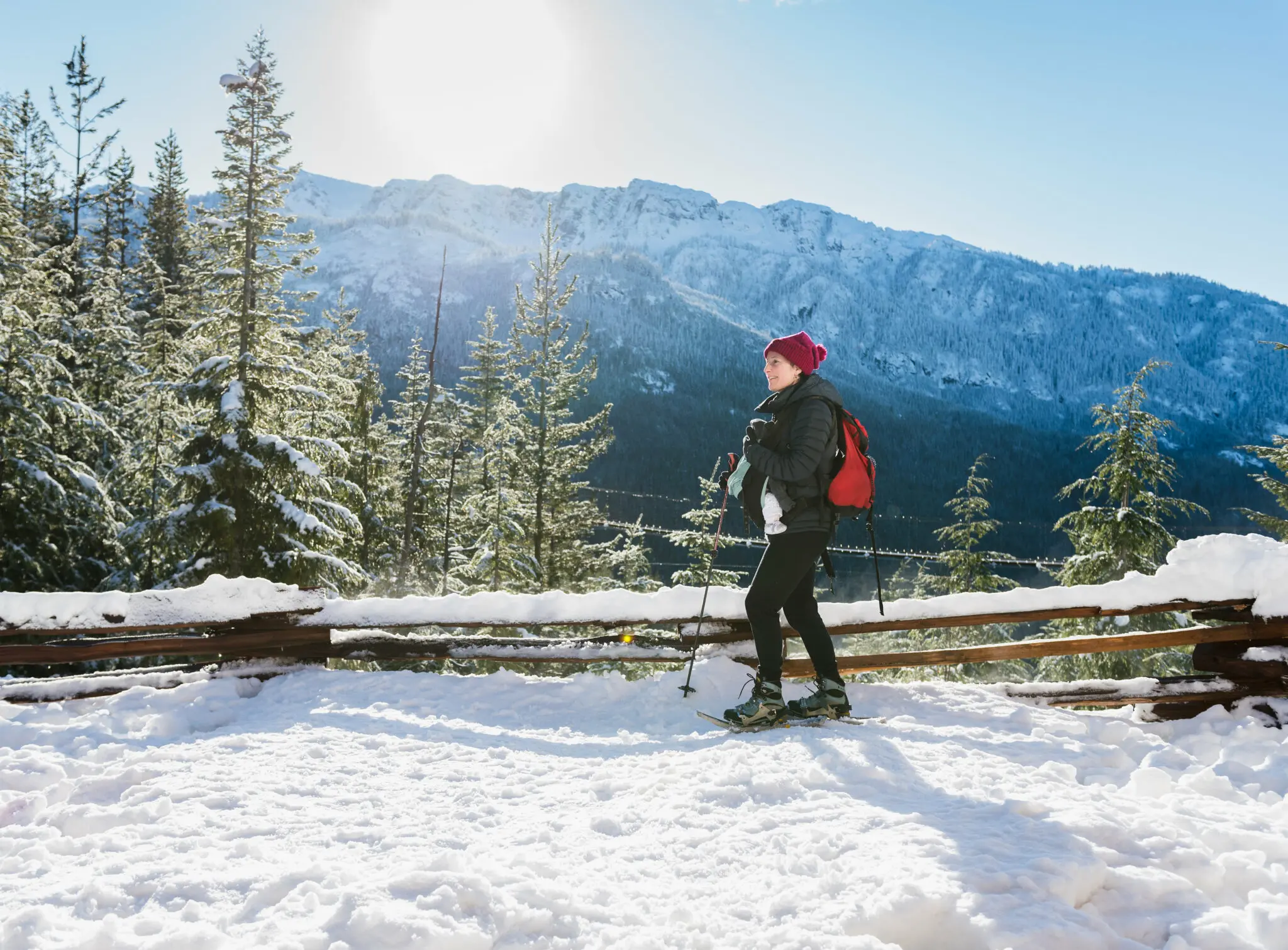 A mom snowshoes carrying a baby