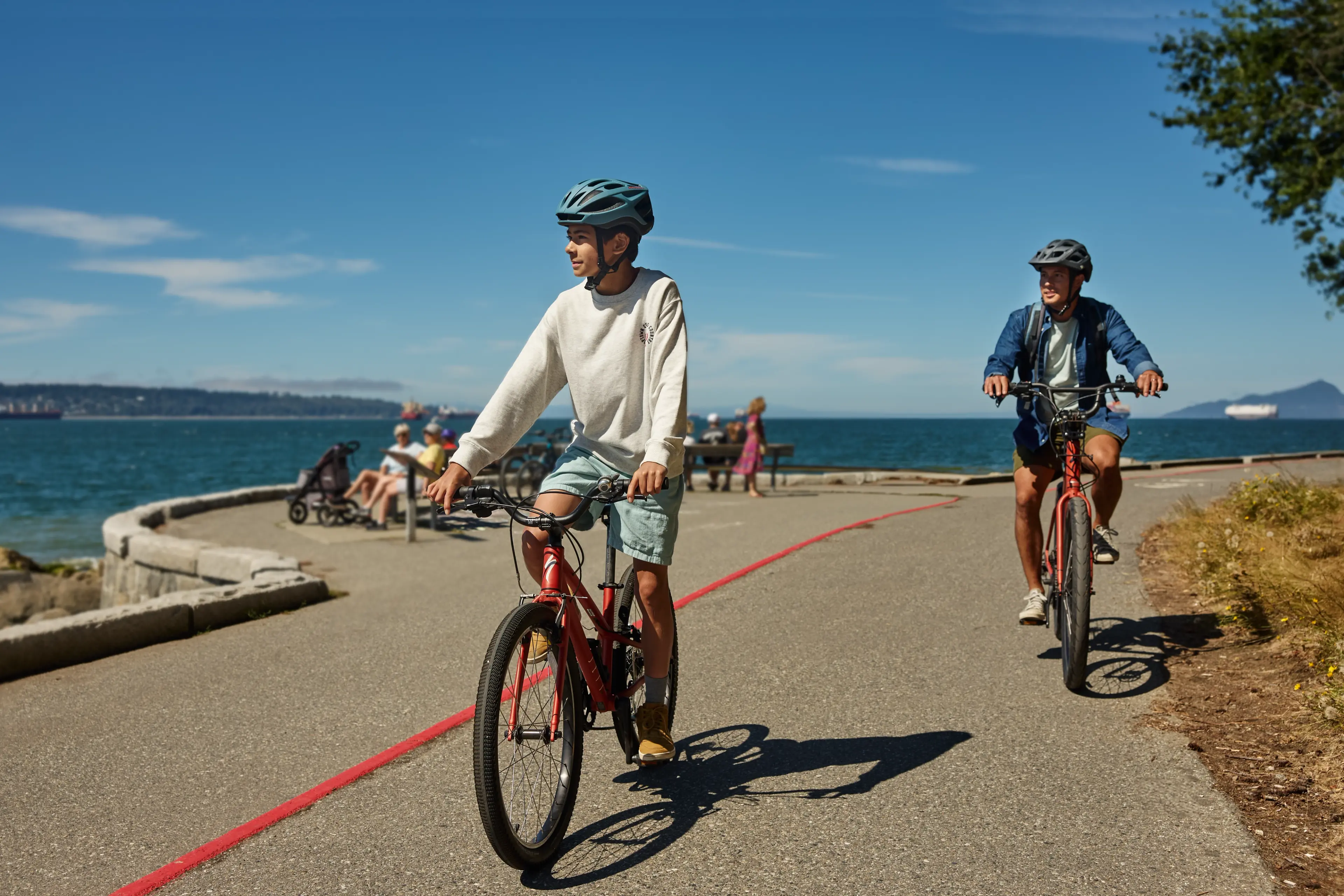 Two people biking the Stanley Park Seawall