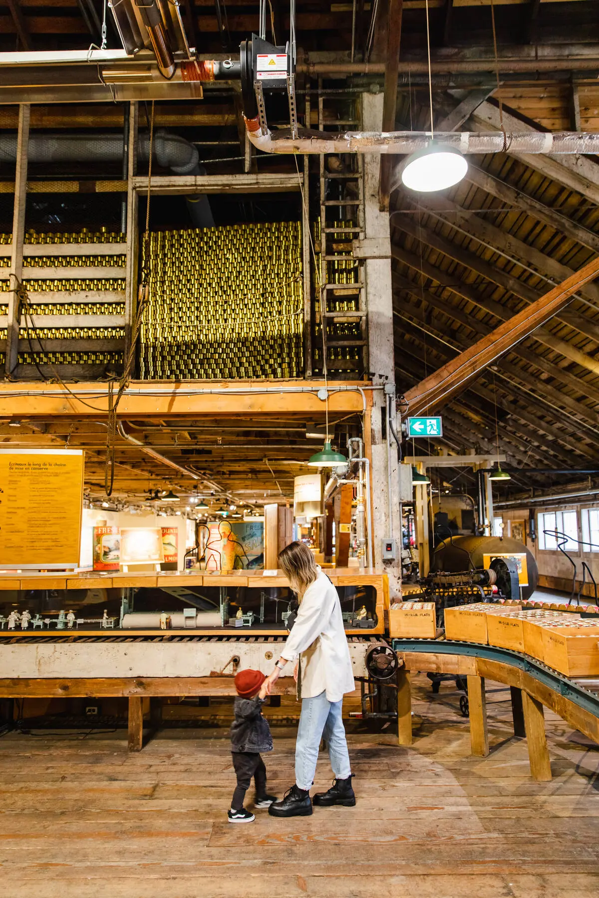 A mother holds hands with her child at the Gulf of Georgia Cannery in Richmond