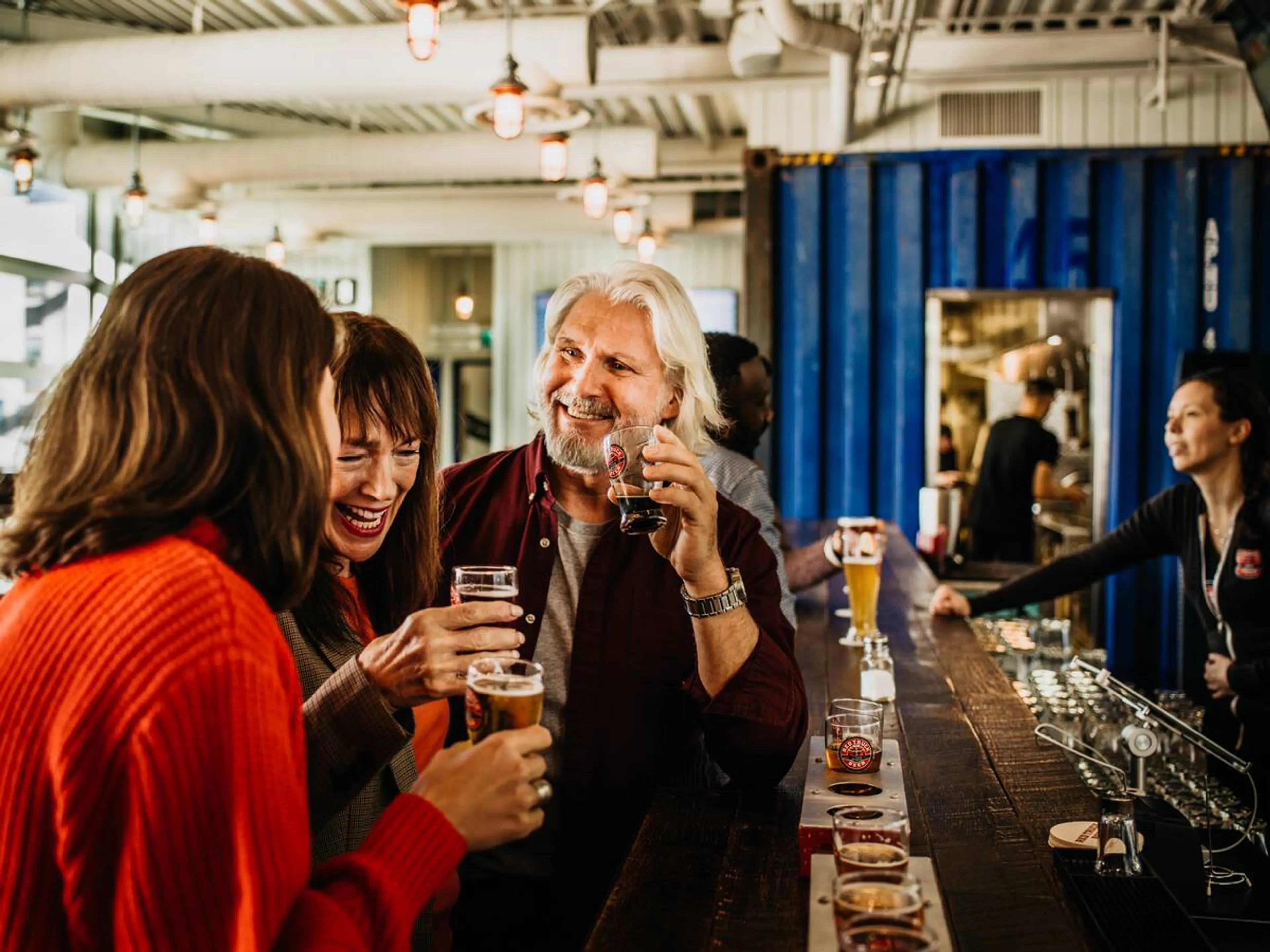 Two people take a photo cheering to their beer at Vancouver Craft Beer Week