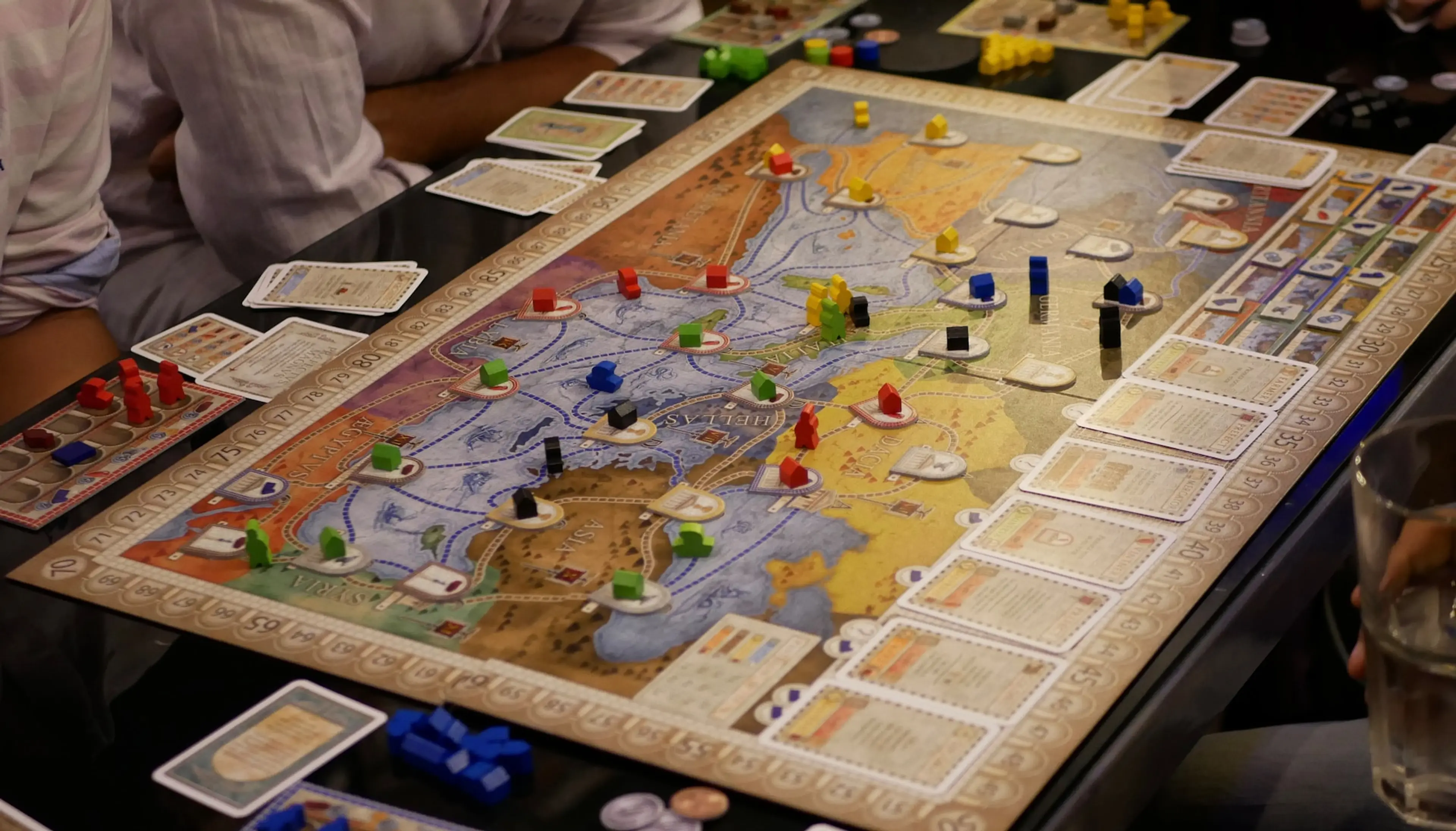 Board with game pieces and cards set up to play Concordia