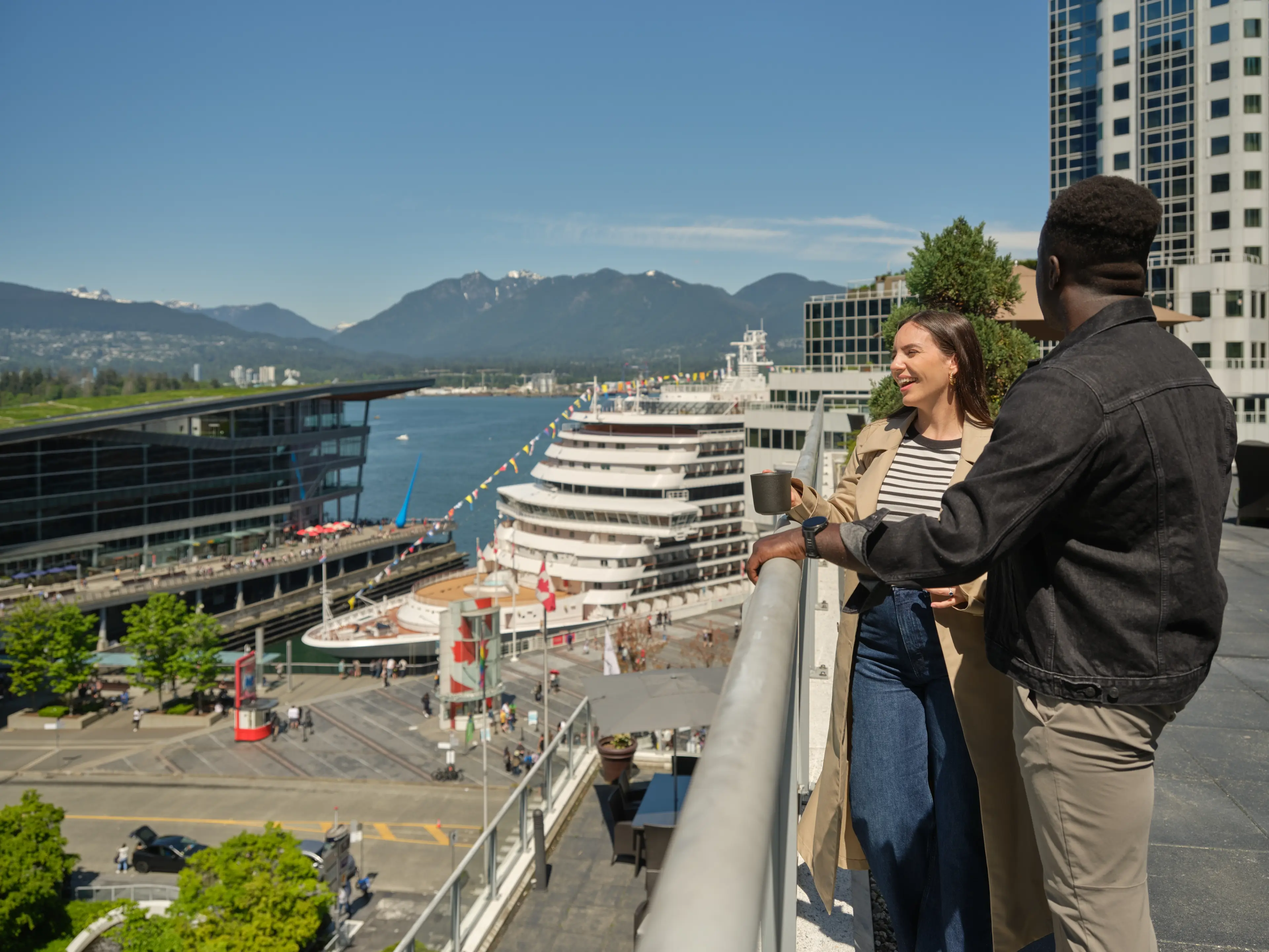 A couple on a roof top looking out to Coal Harbour.