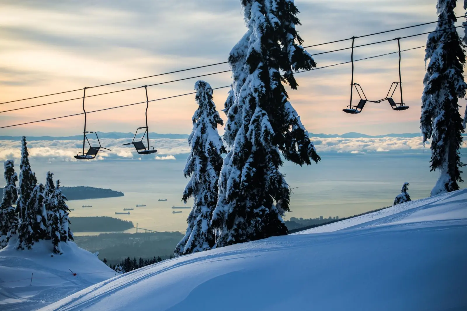 Mount Seymour's chairlifts over the city at dusk