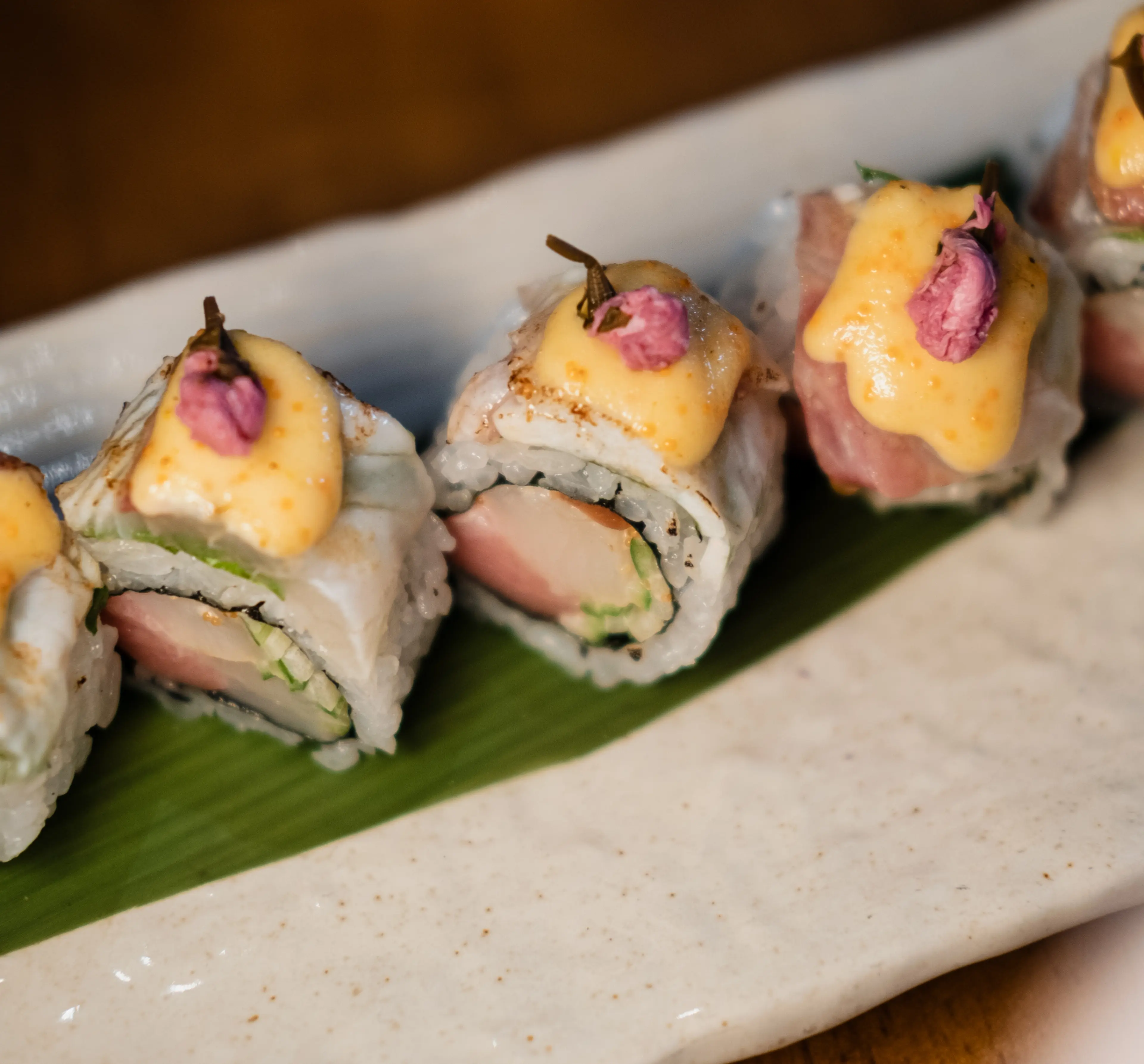 Sushi rolls placed on a plate with a bamboo leaf at The Victor in Vancouver