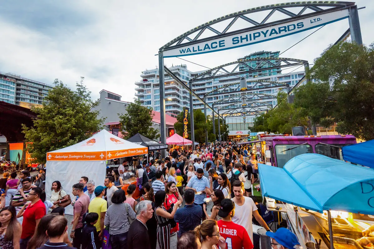 A crowd of people shopping at the Shipyards Market