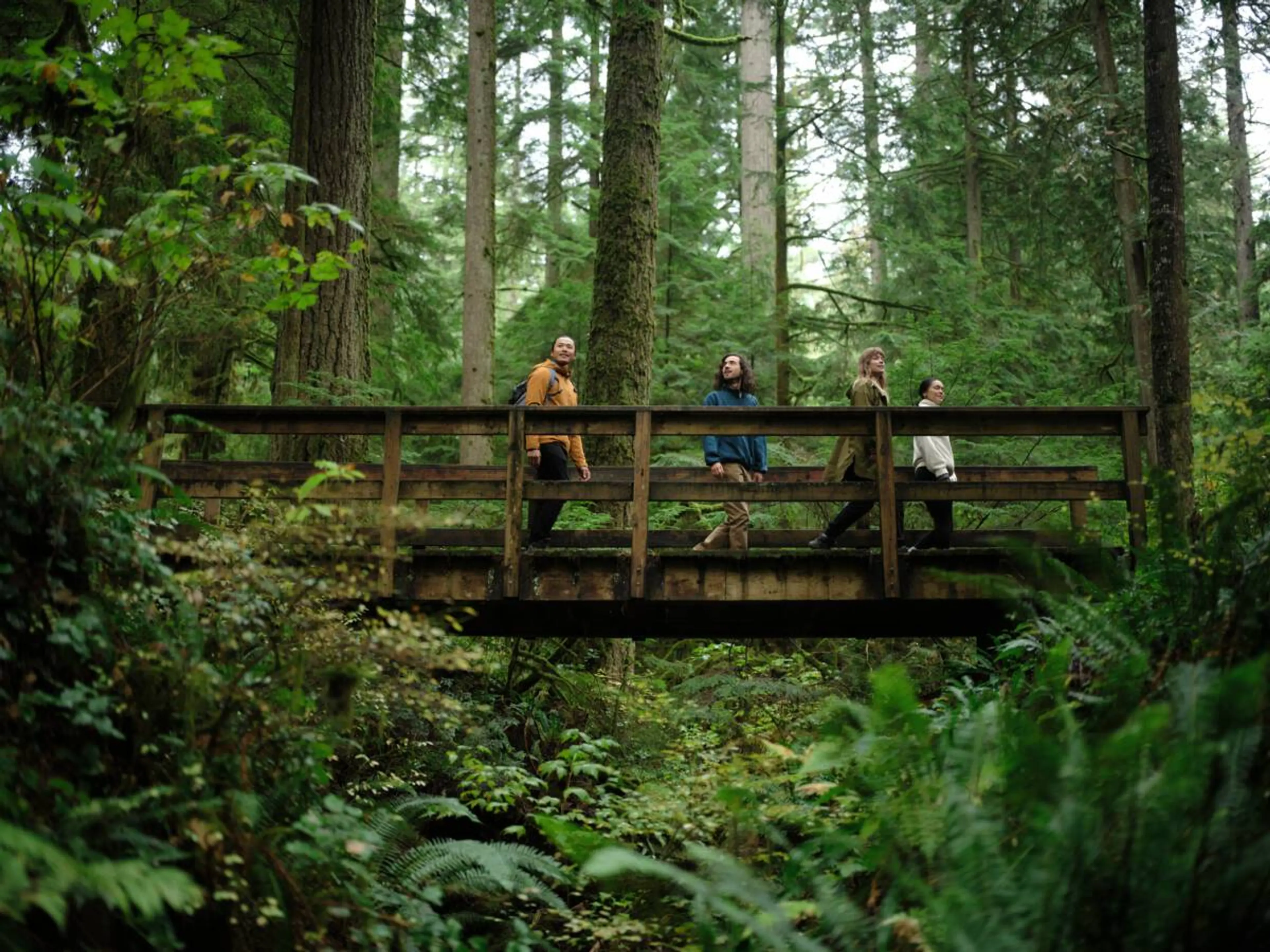A group of people take a break on a bridge during a hike on Vancouver's North Shore. 