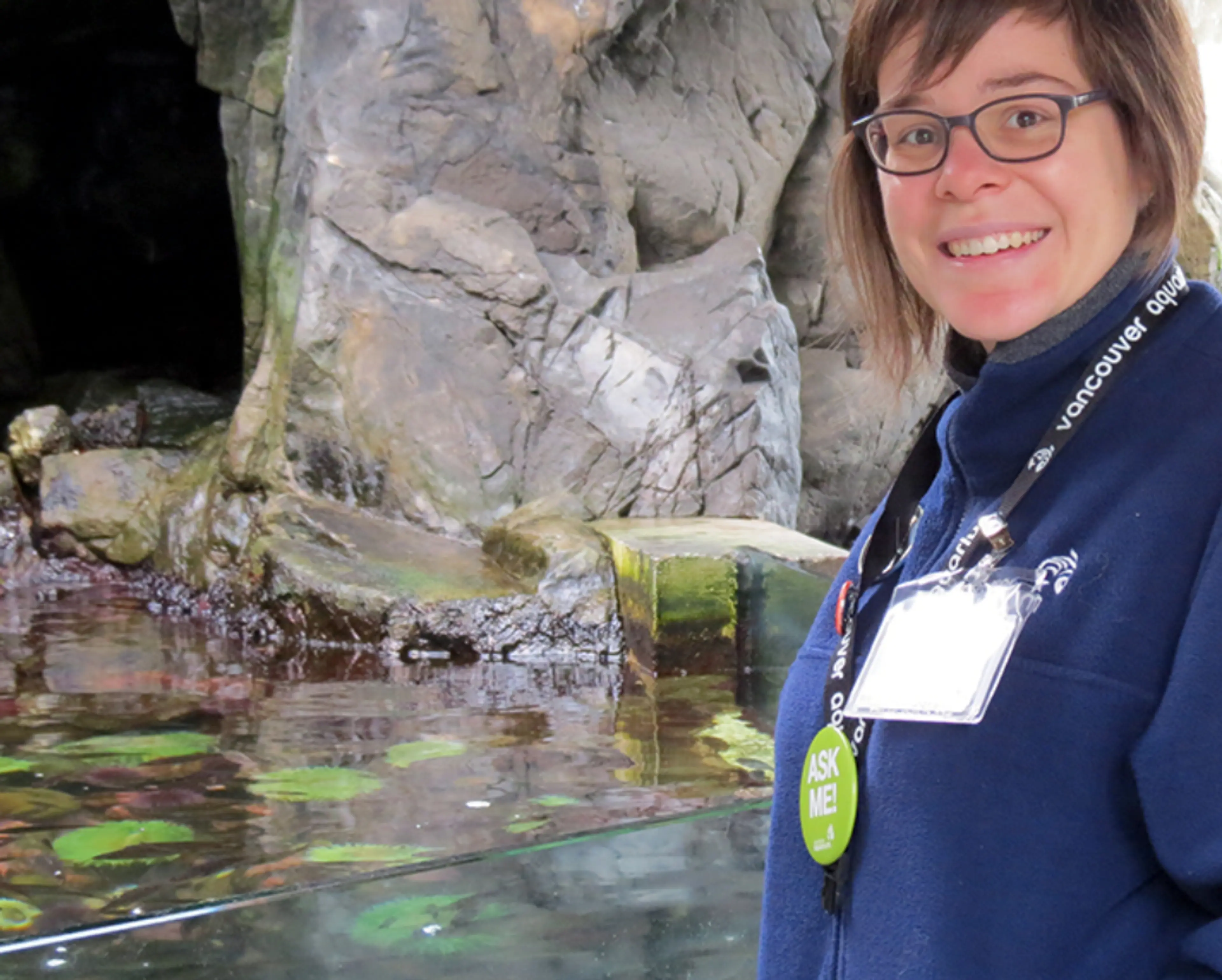 A naturalist stands next to the Touch Pool exhibit at the Vancouver Aquarium
