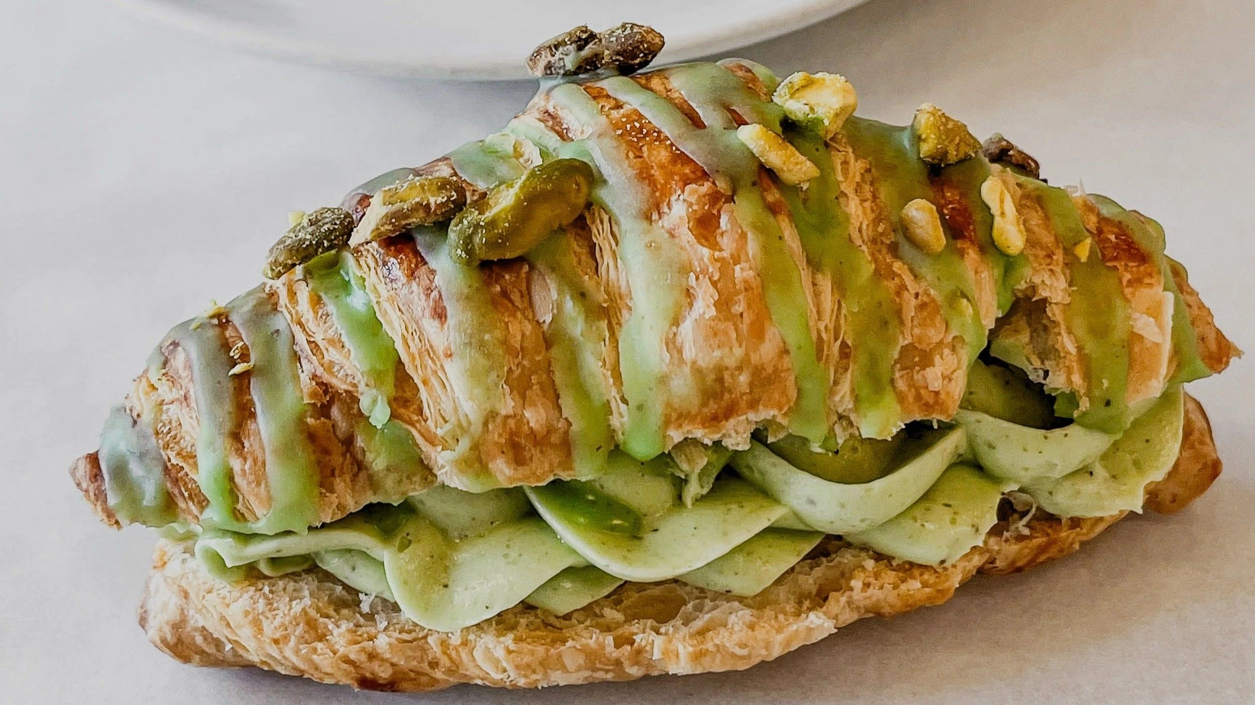 w-2499h-1406-26fa36-Crunchy+Pistachio+Cream+Croissant1
