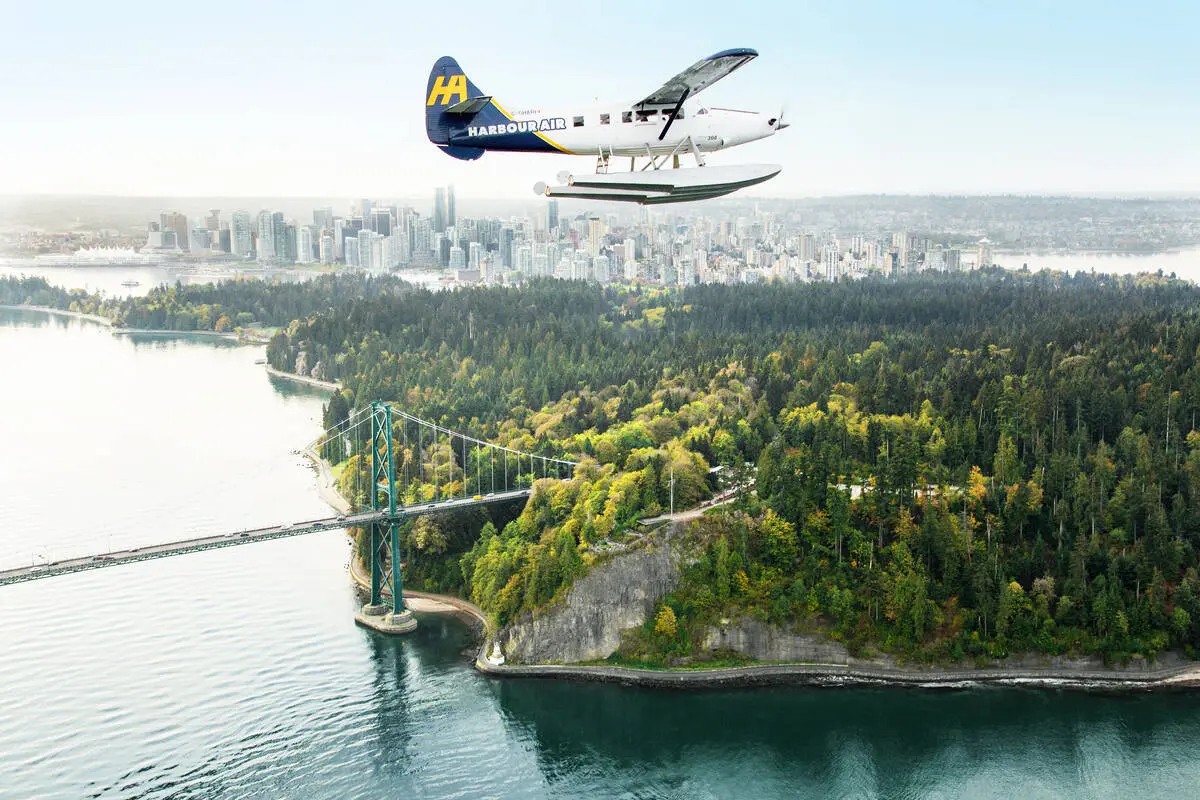 A floatplane soars over Stanley Park.