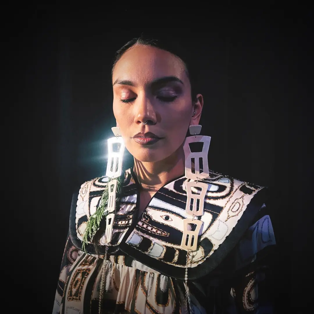 Model Jaymyn La Vallee wearing Pam Baker (dramatic earrings and intricately designed top)