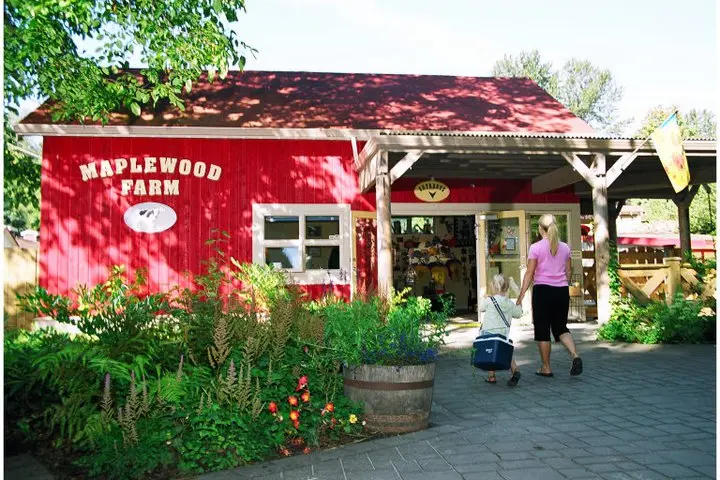 A mother holds hands with her child at the entrance to Maplewood Farm in North Vancouver
