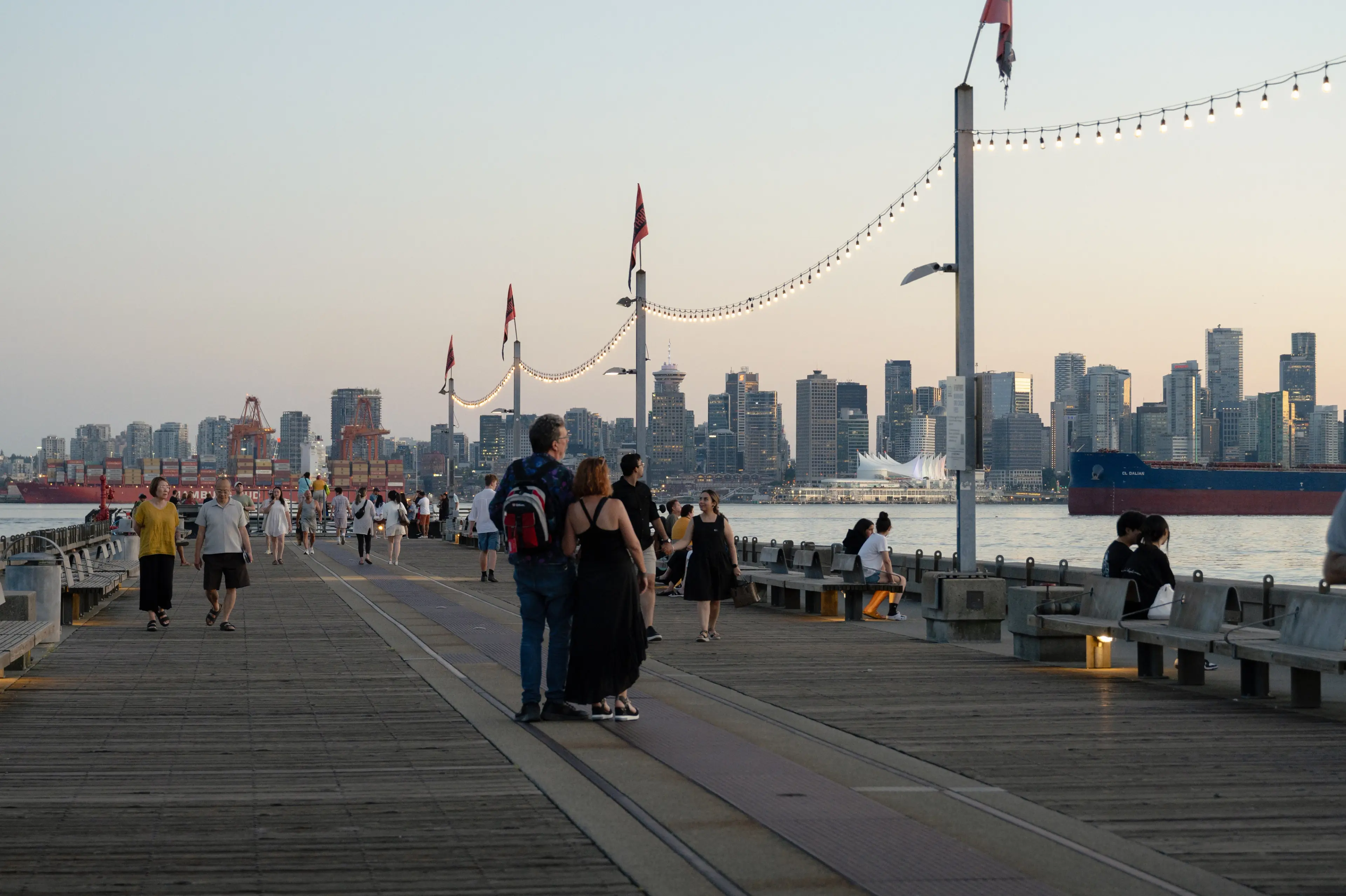 People enjoy the sunset on Shipyards Pier in North Vancouver.
