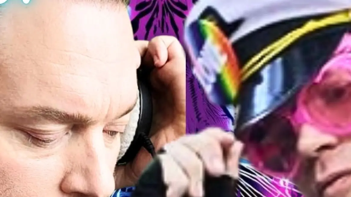 Close-up of two people, one wearing headphones and the other wearing a hat with a rainbow patch and pink sunglasses.