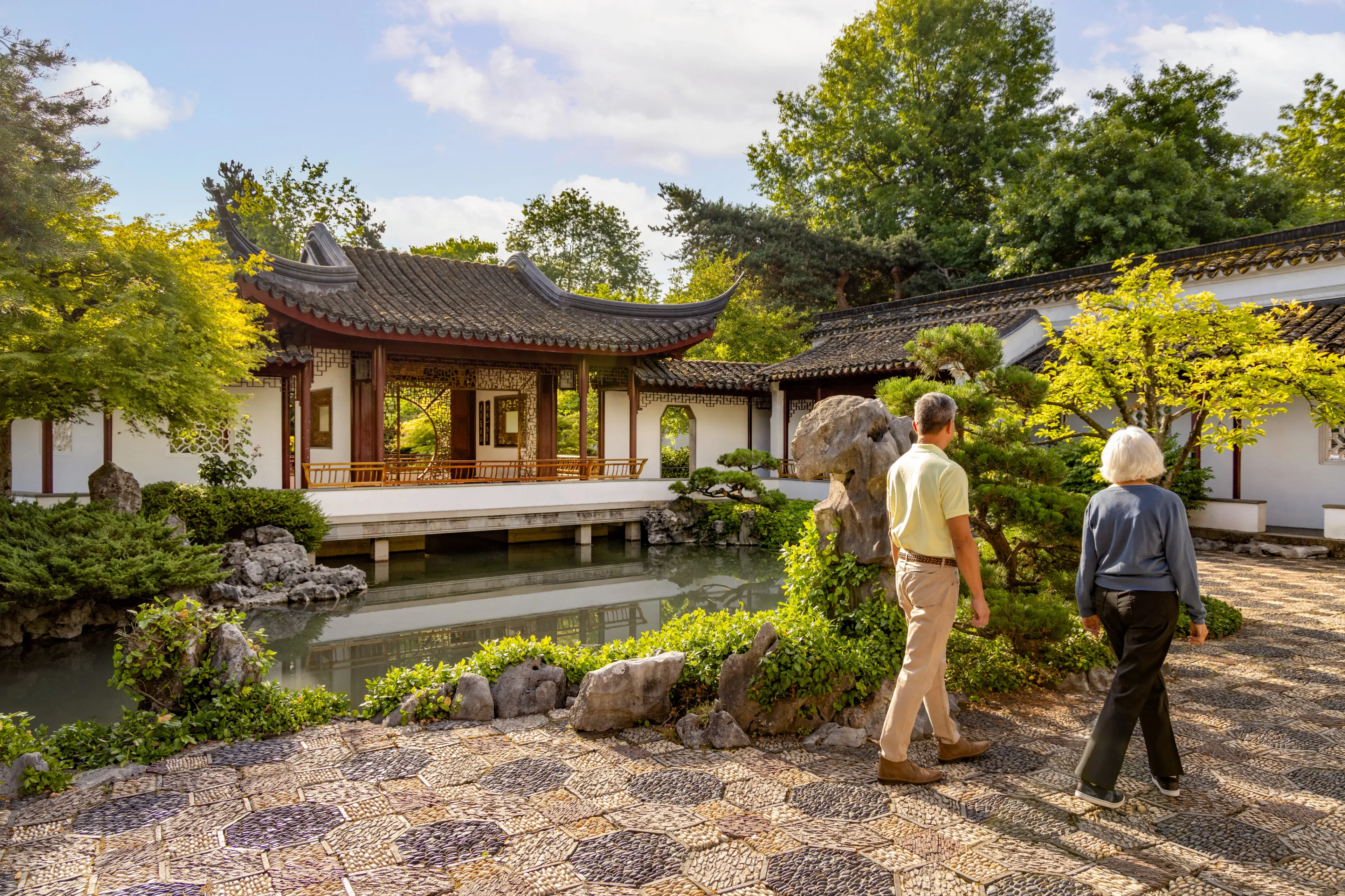 Two people strolling through the grounds of Dr. Sun Yat-Sen Classical Chinese Garden