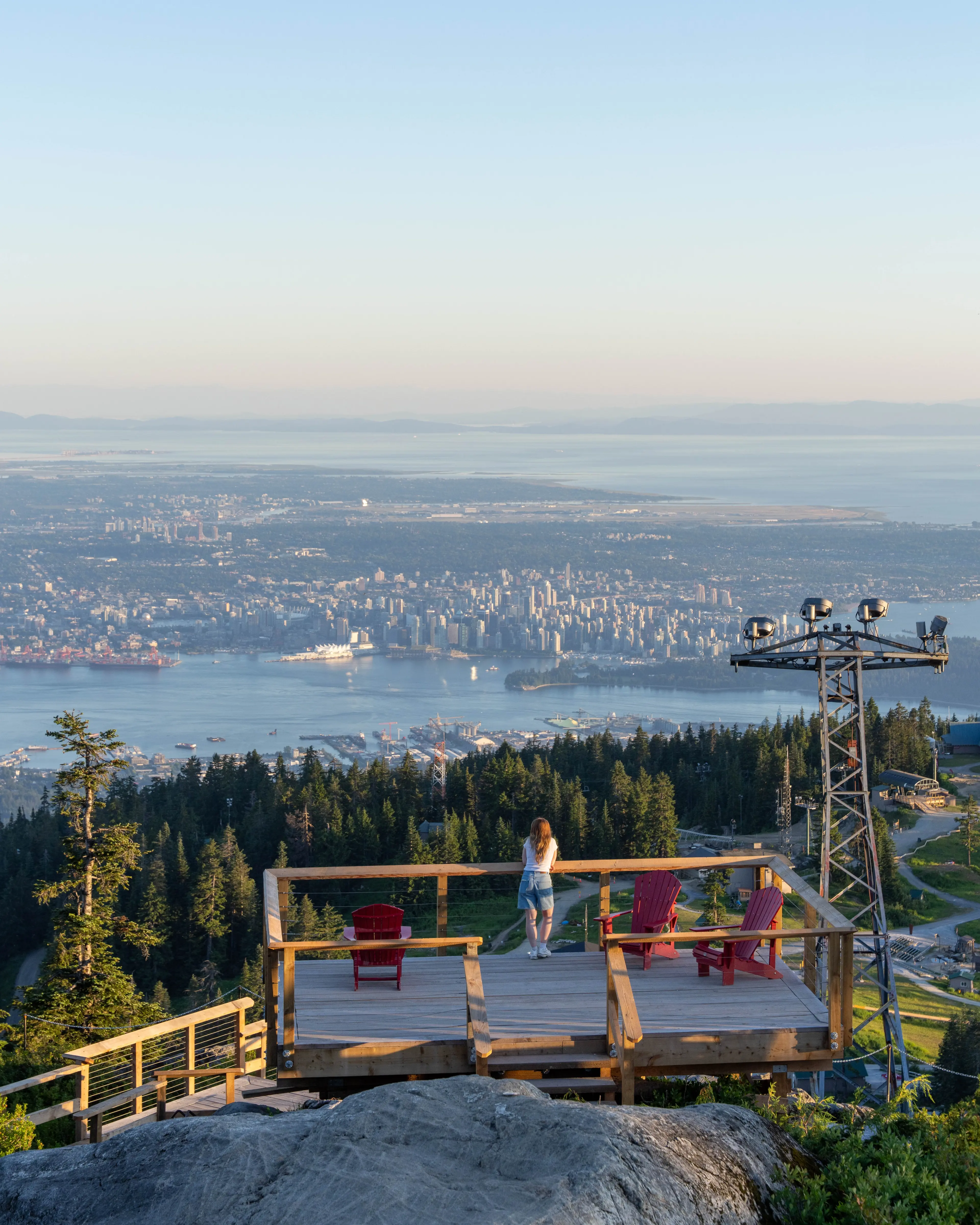 A person looking out from a view point on Grouse Mountain.