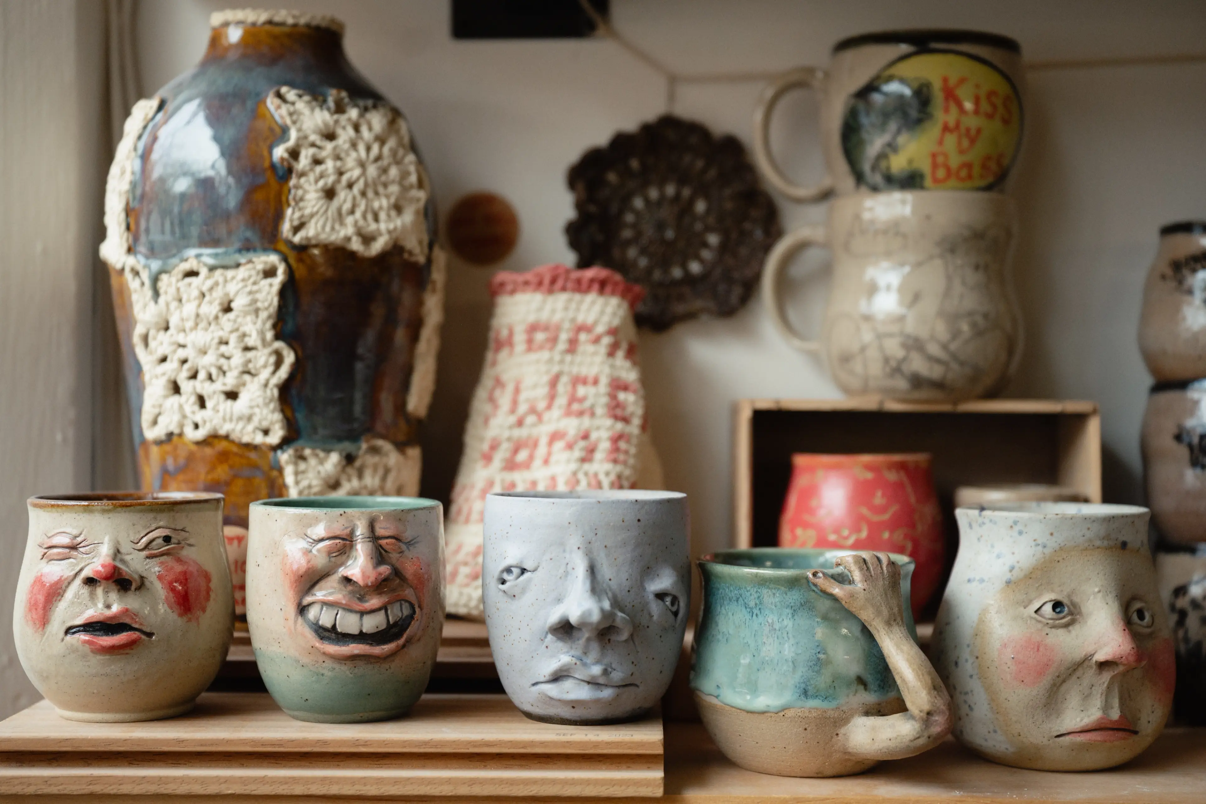 Artistic mugs at Café au Clay Pottery Studio and Café in Vancouver.